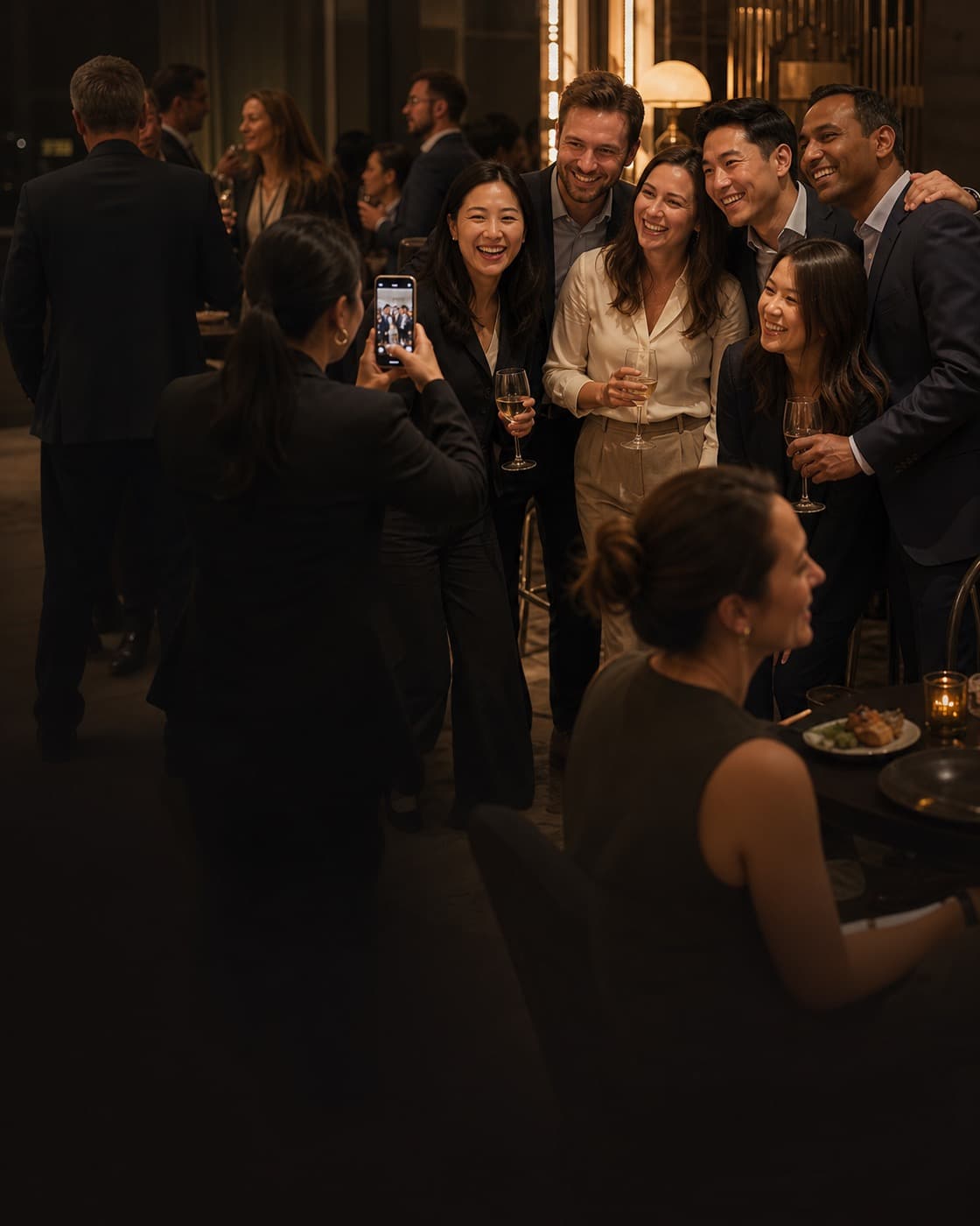 Colleagues capturing a candid group moment at a corporate reception